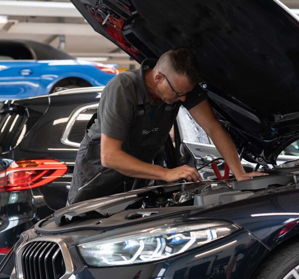 BMW-Monteur-Aan-het-werk-motorkap-open-mobiel