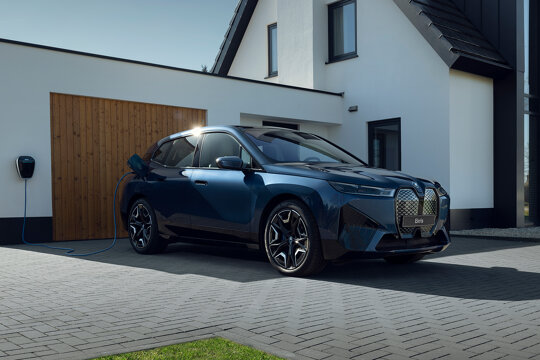 BMW-iX-Blauw-zijkant-garage-oprit-laadpaal